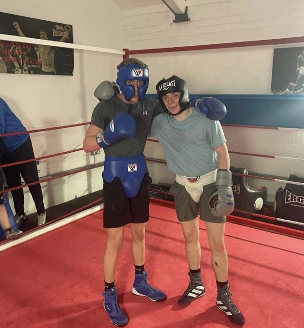 Two boxers sparring with headgear in the Waterloo ABC ring
